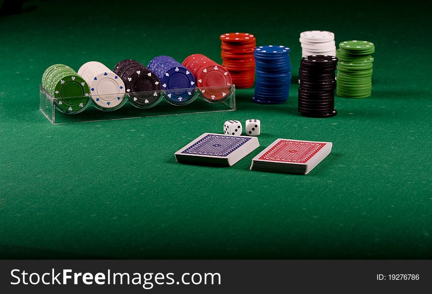 Casino gambling chips on green table. Casino gambling chips on green table