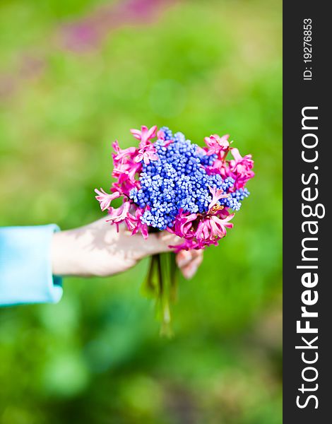 Woman holding flowers bouquet on green background