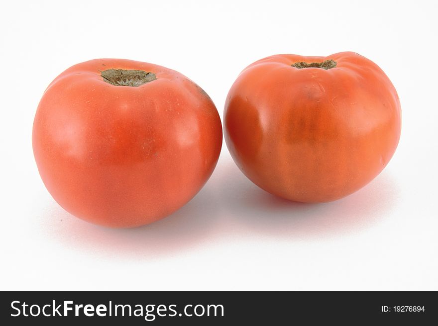 Two ripe tomatoes on a white background. Two ripe tomatoes on a white background
