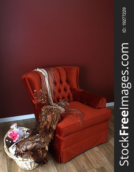 Red chair with basket on wooden floor