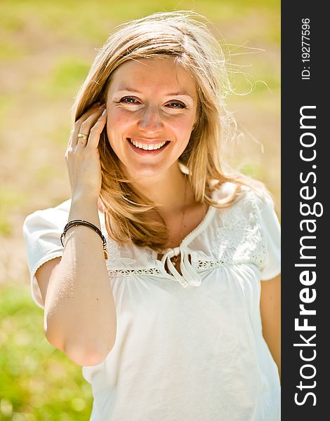 Pregnant woman outdoor in park at spring time