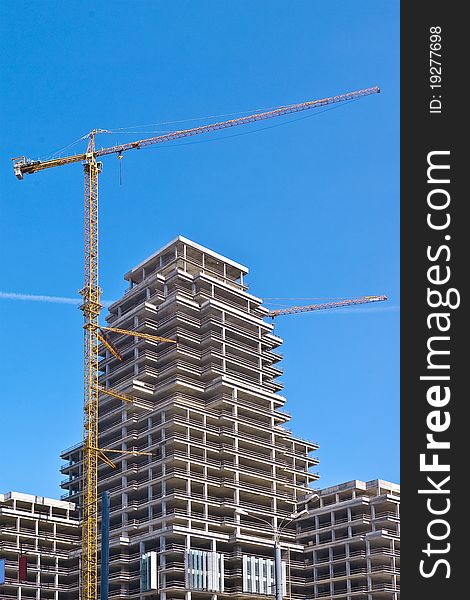 Modern high-rise building with two tower cranes. Modern high-rise building with two tower cranes