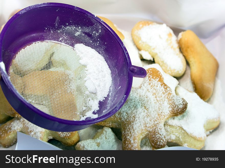 Sprinkling of sugar to shaped traditional cookies. Sprinkling of sugar to shaped traditional cookies