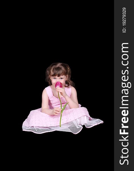 Adorable little girl smelling tulip isolated