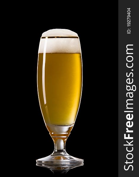 Beer into glass on a black