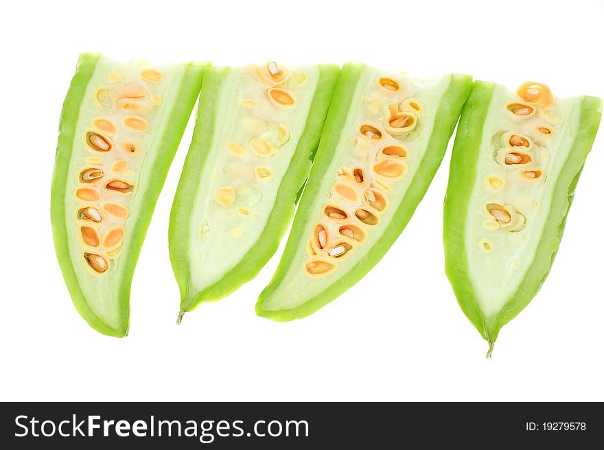 Sectional Cut Of Bitter Gourd Showing The Seeds, Image Is Isolated On White Background