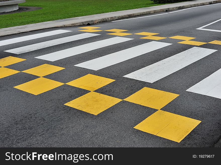 Zebra Crossing On A Road With New Yellow Checker Marking