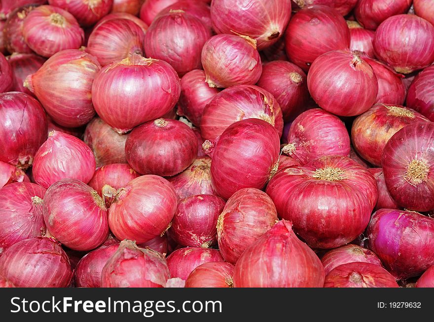 Big Red Onions At A Market Stall. Image Was Captured To Fill Up The Whole Frame Forming A Background
