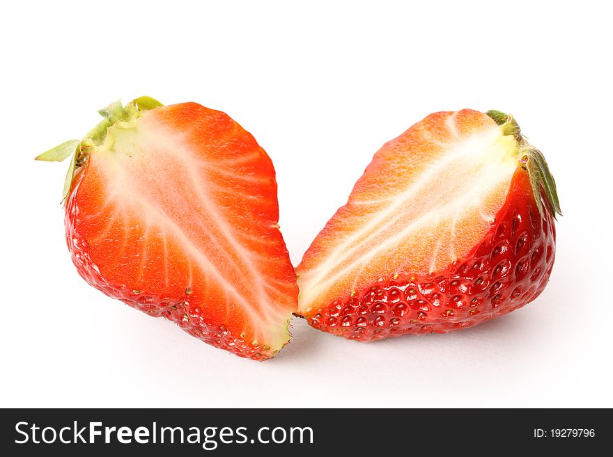 Strawberries cut in half on a white background.