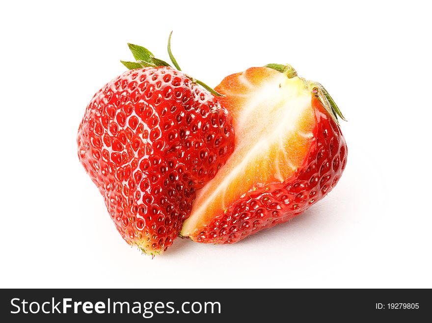 Strawberries cut in half on a white background.