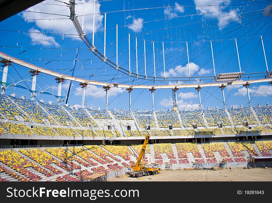 Final stadium works with crane in the middle and clear blue sky