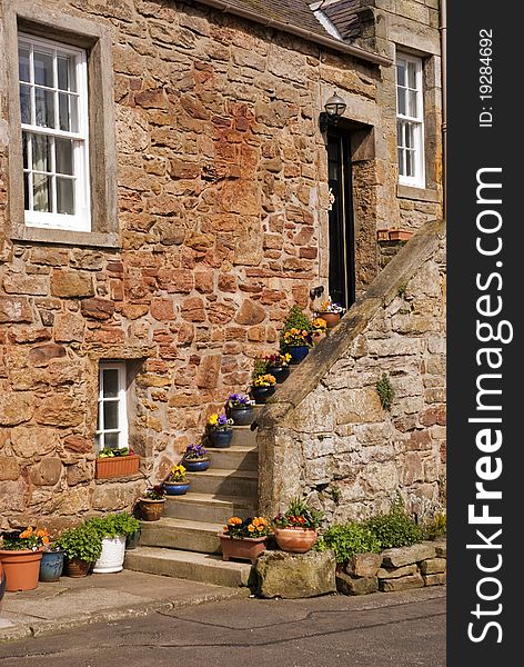 A vertical image of an old house in a fishing village on the east coast of scotland. A vertical image of an old house in a fishing village on the east coast of scotland