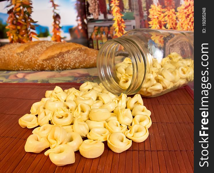Italian cuisine; tortellini pasta from a jar with Italian bread in the background