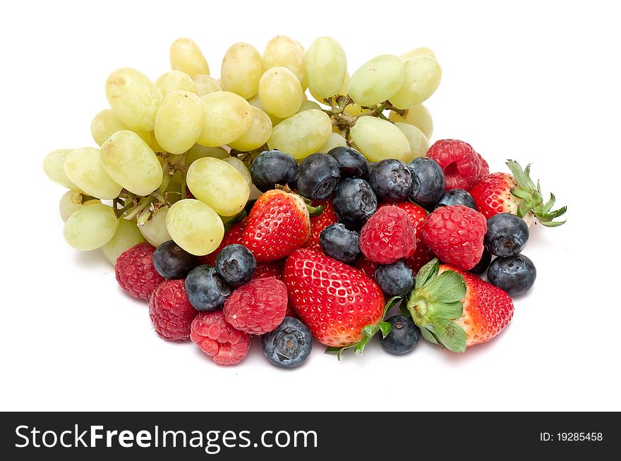 Some berries and grapes over a white background