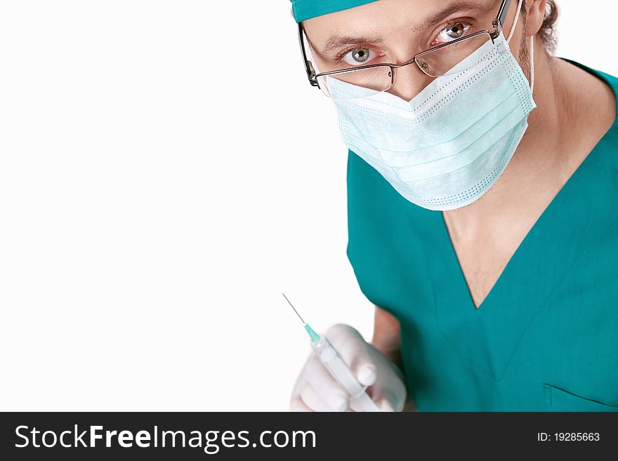 Doctor in a mask holding a syringe isolated. Doctor in a mask holding a syringe isolated