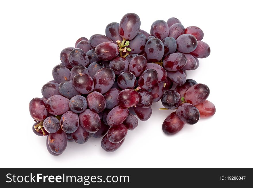 Some fresh blue grapes over a white background