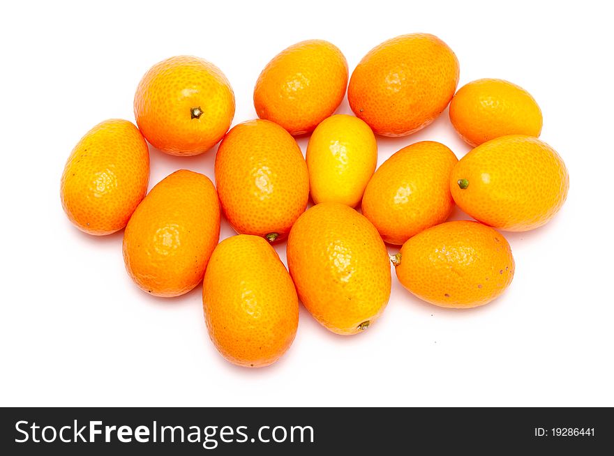 Some fresh kumquats over a white background