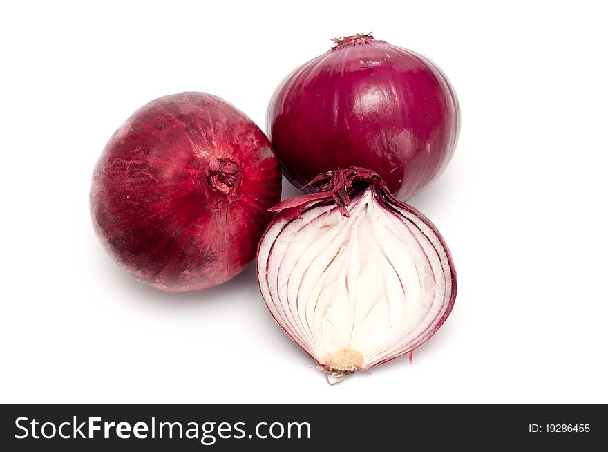 Fresh red onions over a white background