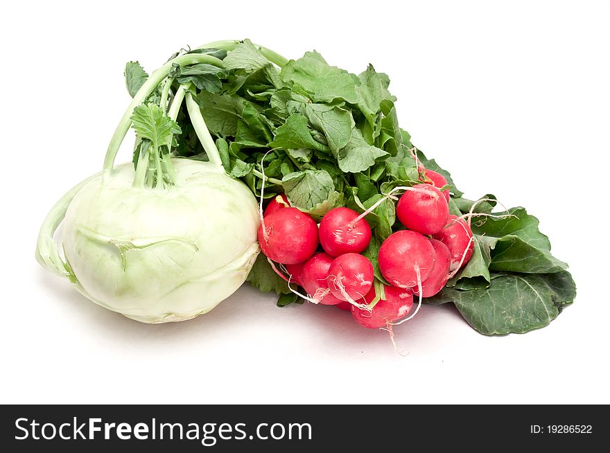 Fresh kohlrabi and radishes over a white background. Fresh kohlrabi and radishes over a white background
