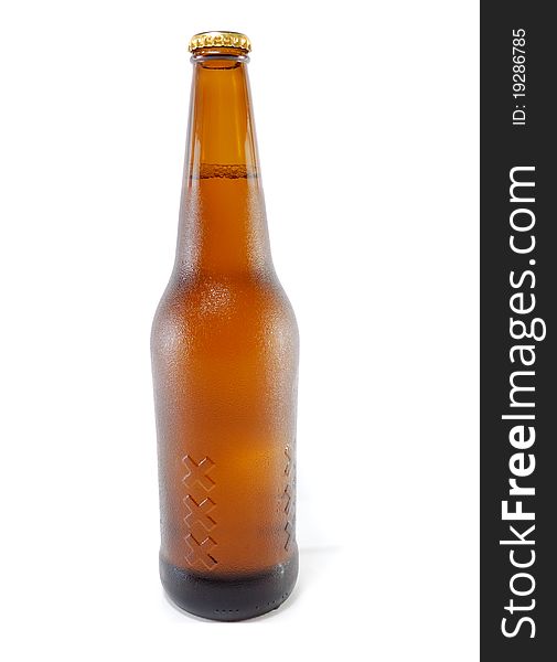 Brown bottle of beer with drops are isolated on a white background