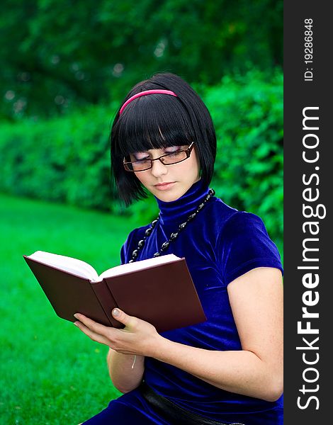 Happy young woman writing book, green nature background. Happy young woman writing book, green nature background.