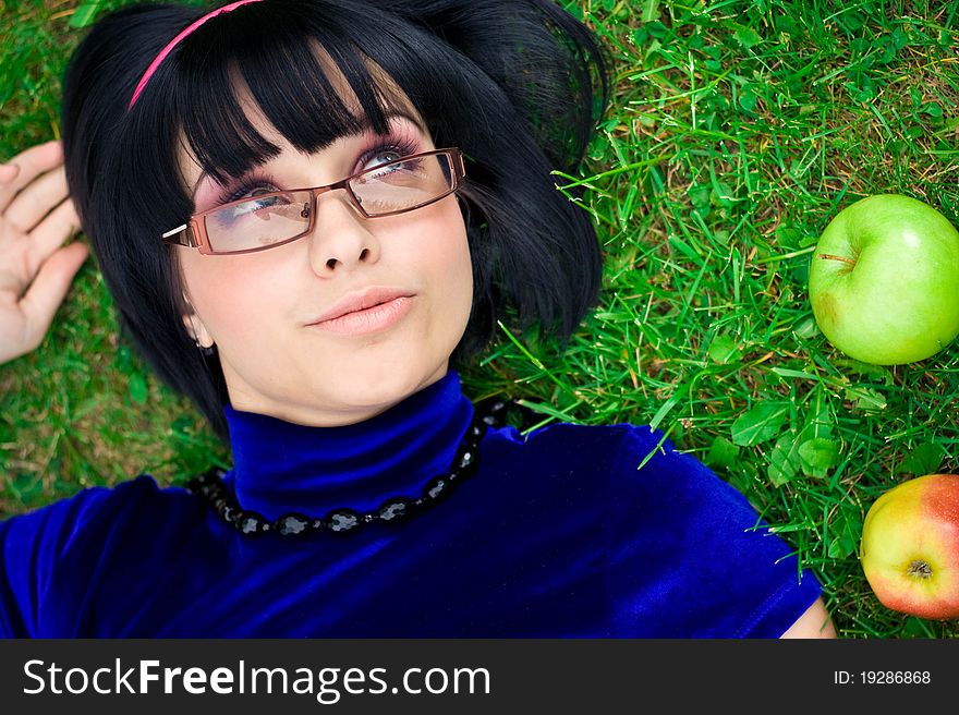 Happy young woman with ripe apple, green nature background. Happy young woman with ripe apple, green nature background.