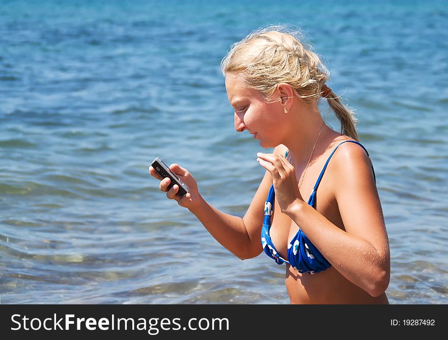 Girl With The Phone Against The Sea