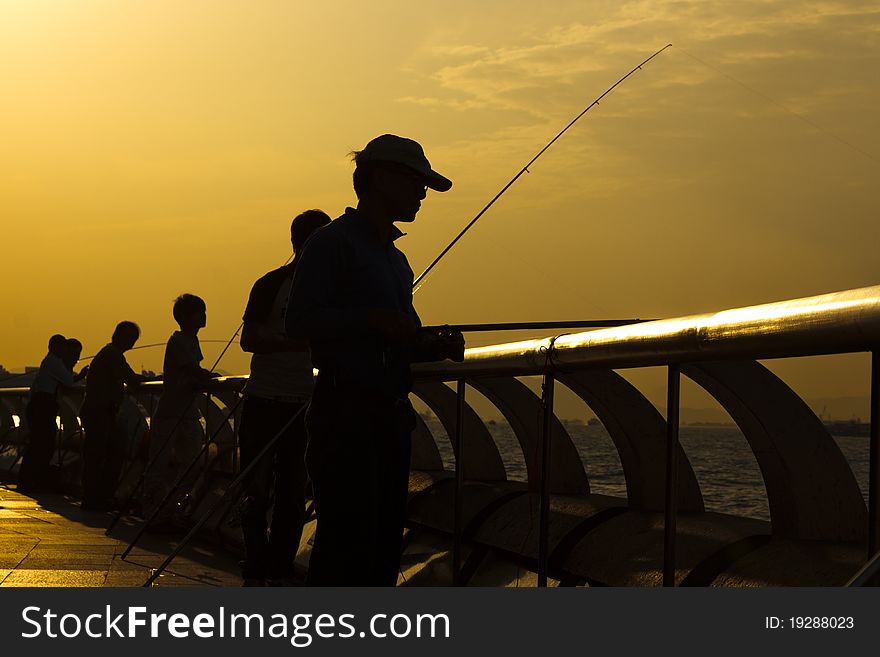 Fisherman in Hong Kong sunset seaside