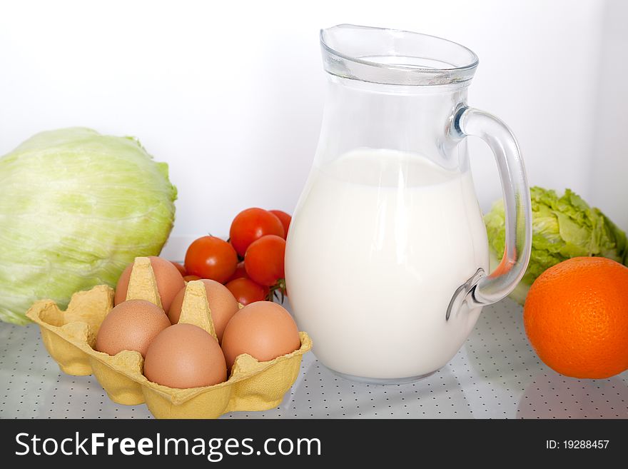 Refrigerator with some kinds of food - vegetables, milk, eggs. Refrigerator with some kinds of food - vegetables, milk, eggs