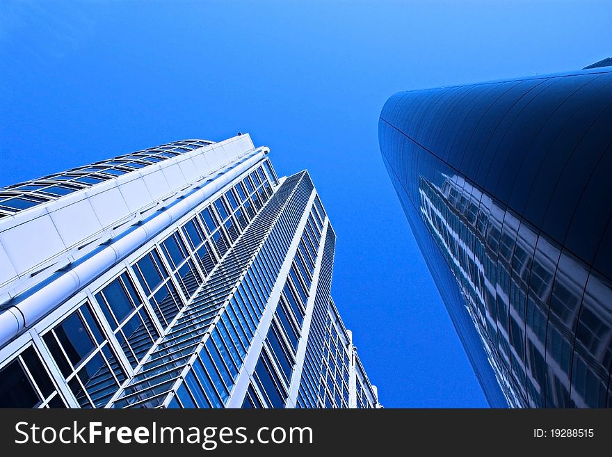 Wide angle shot of 2 buildings from the city scene, image has added blue filter effect for amore blue,crisp,clean look. Wide angle shot of 2 buildings from the city scene, image has added blue filter effect for amore blue,crisp,clean look.