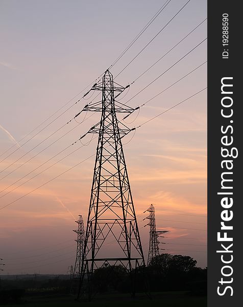 Electricity pylons on a freeway at Dusk time, little grain added to the sky to prevent banding and to give a nicer blending effect. Electricity pylons on a freeway at Dusk time, little grain added to the sky to prevent banding and to give a nicer blending effect