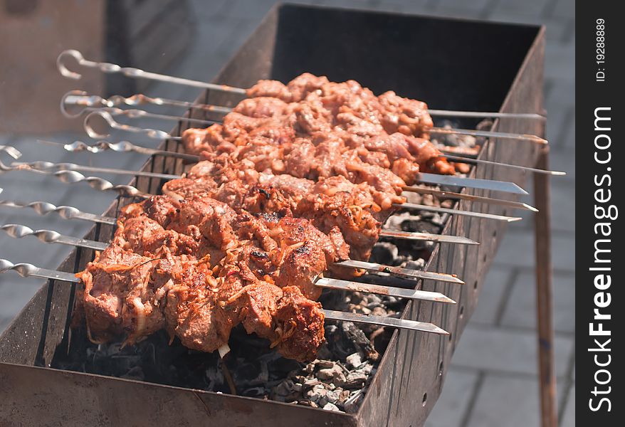 Cooking shish kebab of pork with onions