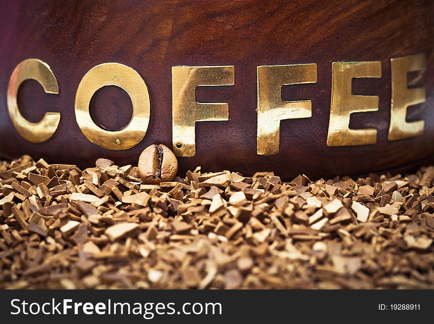 Closeup of a coffee bean with a wooden word coffee. Closeup of a coffee bean with a wooden word coffee