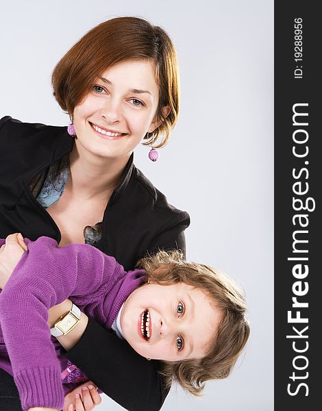 Young mother with her daughter, studio photo