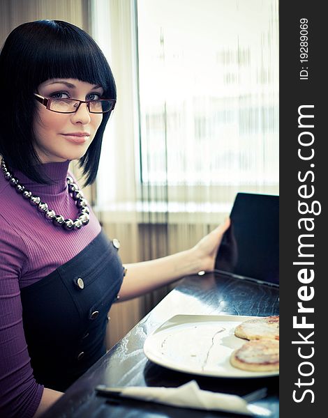 Young woman in cafe with touch screen tablet