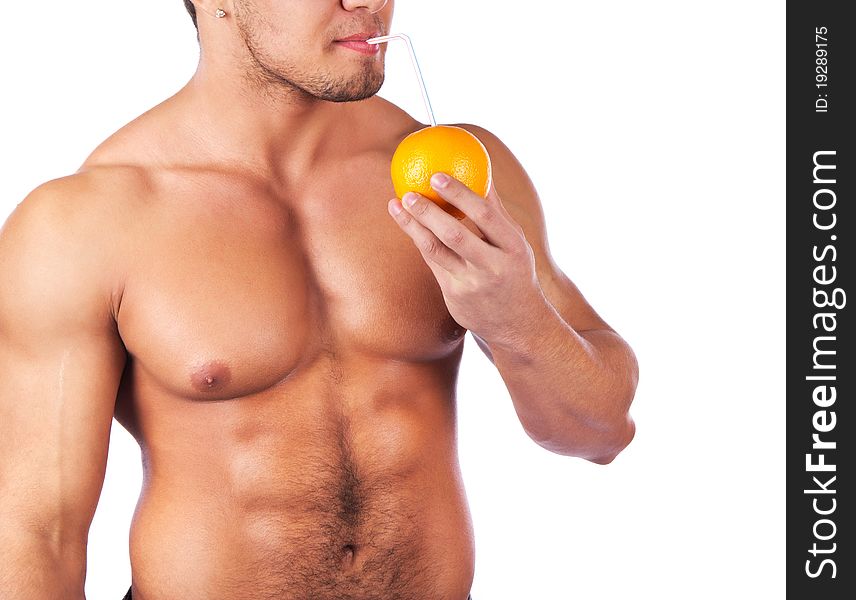 Man is holding an orange and drinking. Man is holding an orange and drinking