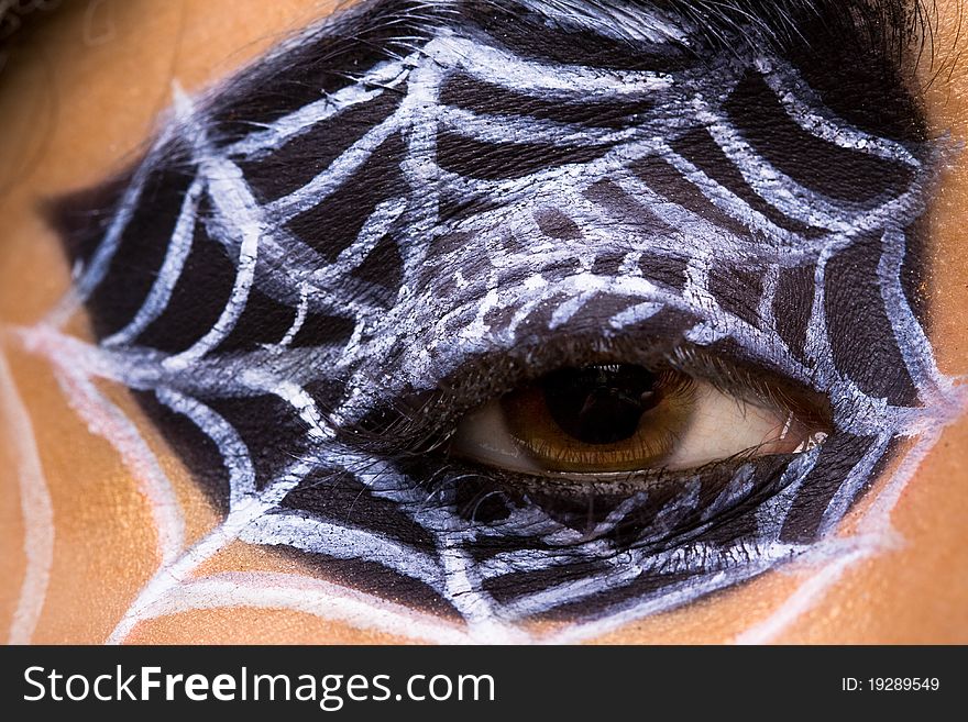 Young woman with spider makeup and cobwebs in hair,. Young woman with spider makeup and cobwebs in hair,