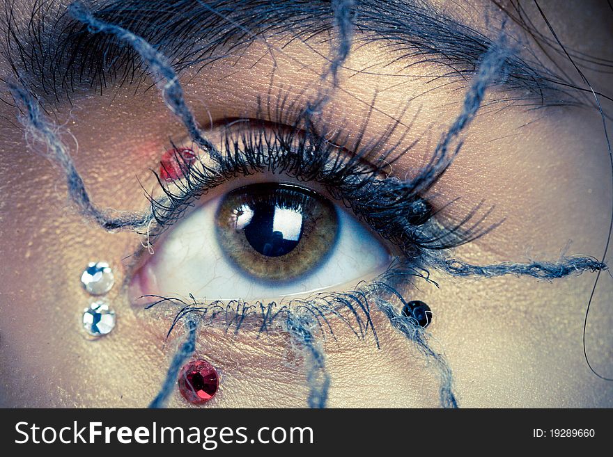 Young woman with spider makeup and cobwebs in hair,. Young woman with spider makeup and cobwebs in hair,