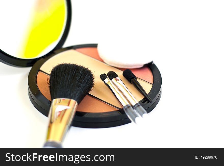 Makeup brushes and blush on white background