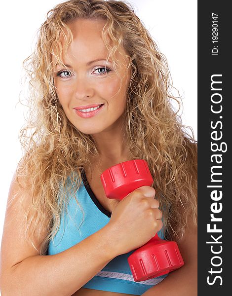 Sportswoman is smiling and holding weights. Sportswoman is smiling and holding weights