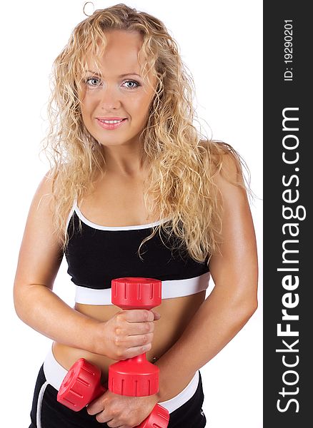 Mature sportswoman is holding red weights. Mature sportswoman is holding red weights