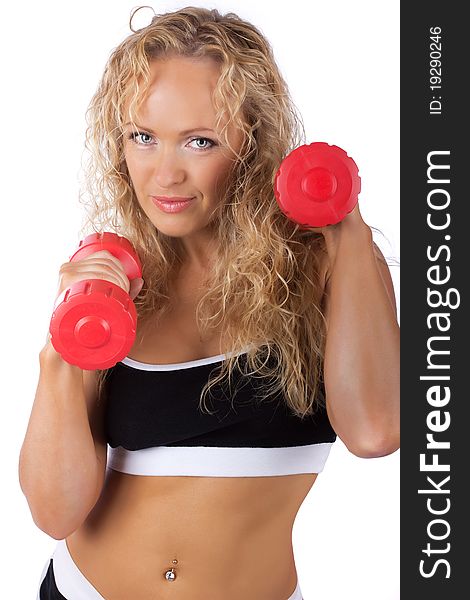 Cute blonde is lifting red dumbbells. Cute blonde is lifting red dumbbells