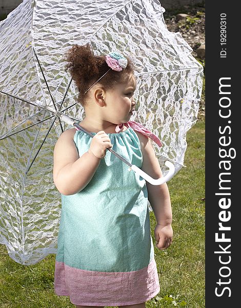 Young girl holding an umbrella during spring time