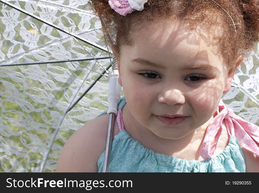 Young girl holding an umbrella during spring time