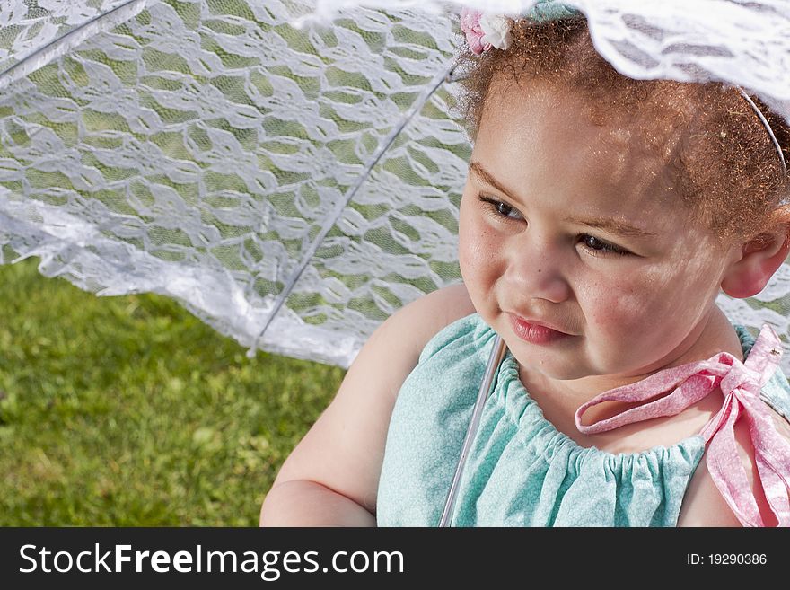 Young girl holding an umbrella during spring time