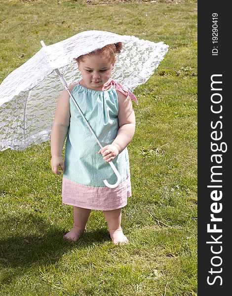 Young girl holding an umbrella during spring time