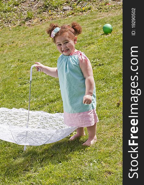 Young girl holding an umbrella during spring time