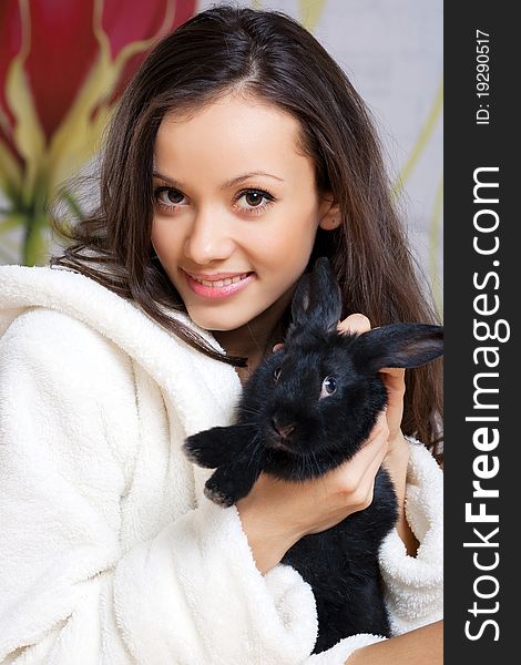Young woman and black rabbit