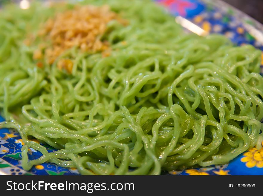 Green noodle with fried garlic ready to serve on dish. Green noodle with fried garlic ready to serve on dish