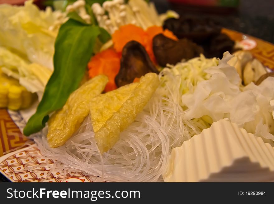 Various vegetables in set on dish included mushroom, canton, morning glory, carrot, cabbage, etc. tilted left. Various vegetables in set on dish included mushroom, canton, morning glory, carrot, cabbage, etc. tilted left